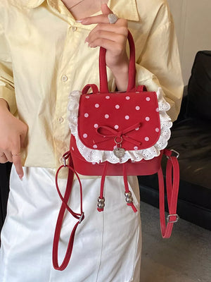 Red backpack featuring lace trim and polka dot