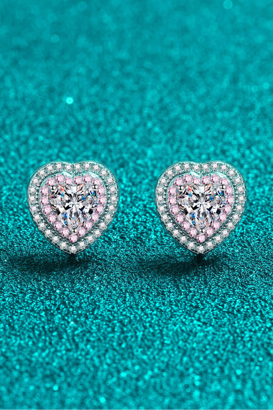 Silver heart halo stud earrings with pink accents and clear crystal center.