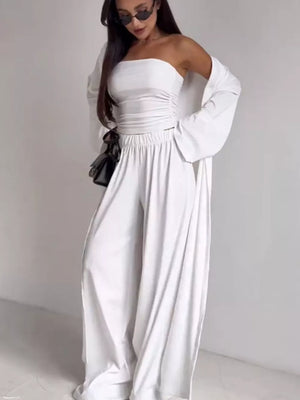 White ruched strapless crop top with wide-leg pants and a flowing cardigan.