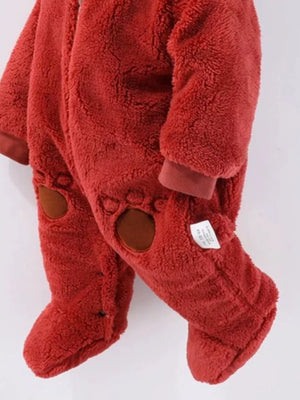 Red fleece baby snowsuit with bear paw details on legs.