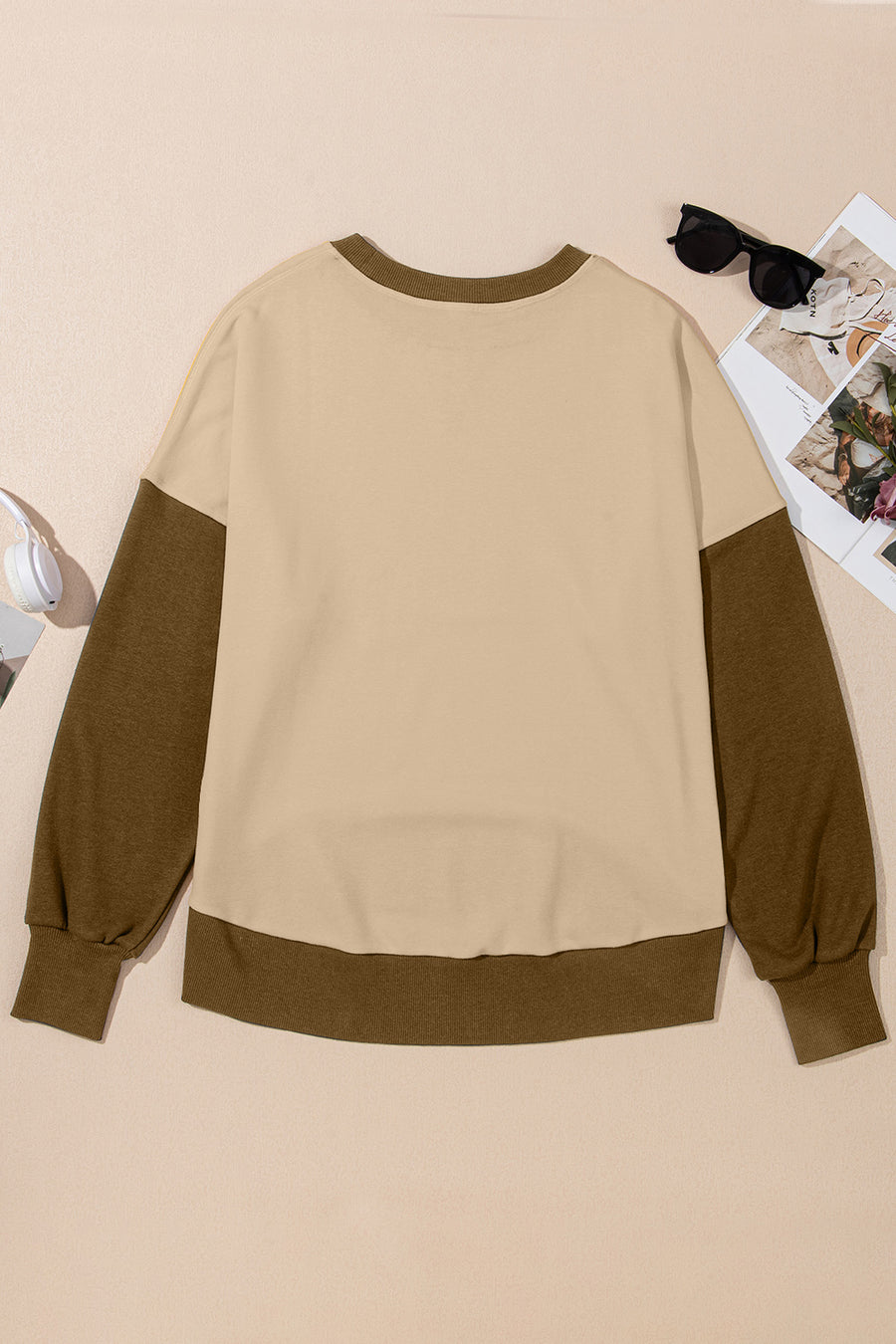 Crewneck sweatshirt in tan with contrasting brown sleeves and hem.