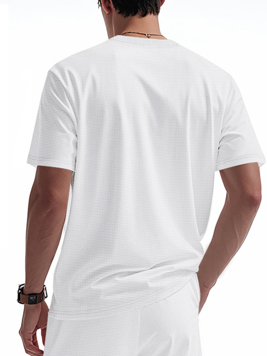 White cotton t-shirt with a subtle waffle knit texture and short sleeves.