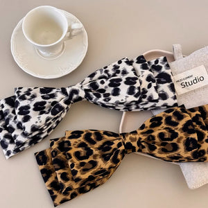 Oversized leopard print hair bows in black and white and brown and black patterns.