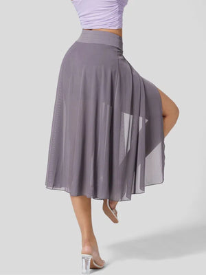 Flowy midi skirt in grey with a thigh-high slit and shorts liner, featuring a drawstring waist.