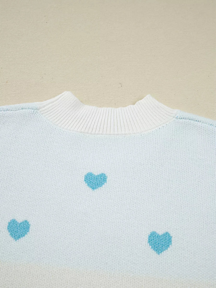 Light blue knit sweater with white crew neck and scattered blue hearts pattern.