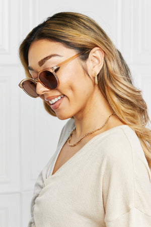 Tortoiseshell round frame sunglasses with tan acetate frames and brown lenses.