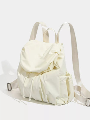 Cream nylon drawstring backpack with flap closure and side pockets