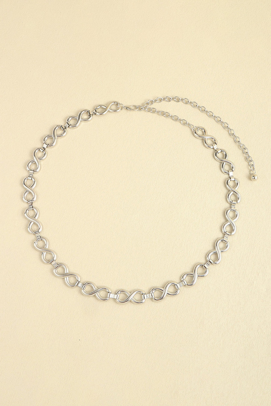 Silver infinity chain waist belt with adjustable extender.