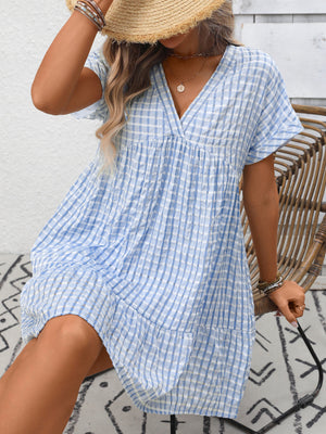 Light blue plaid v-neck mini dress with short sleeves and tiered hem.