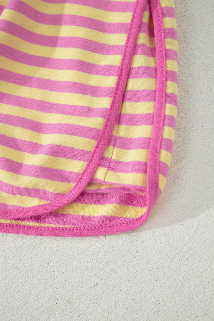 Cotton two-piece set with pink and yellow horizontal stripes and pink trim detail.