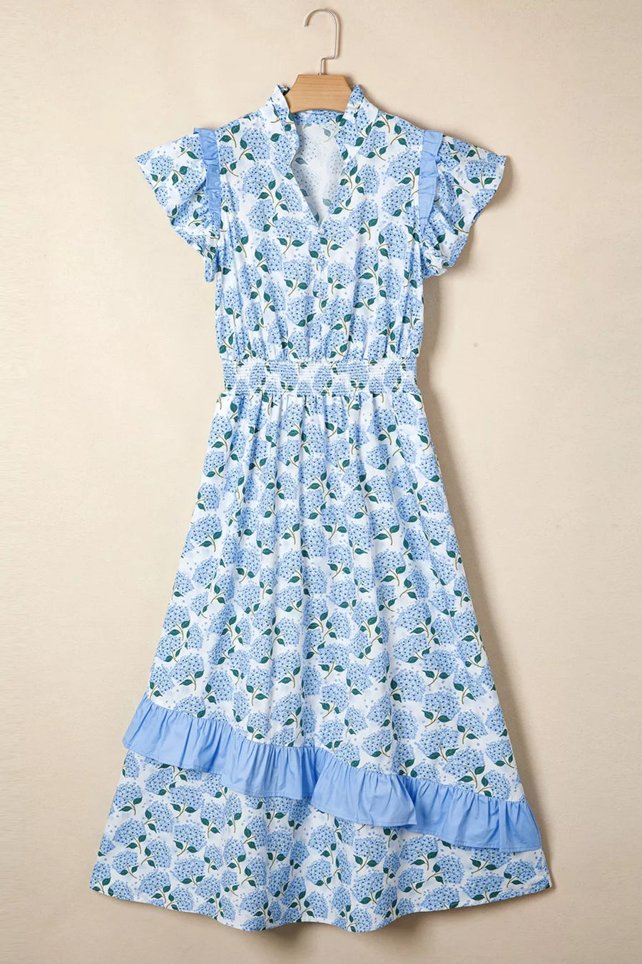 Blue hydrangea print midi dress with flutter sleeves, smocked waist, and ruffled tiers.