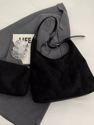 Black suede hobo bag with adjustable strap and matching pouch.