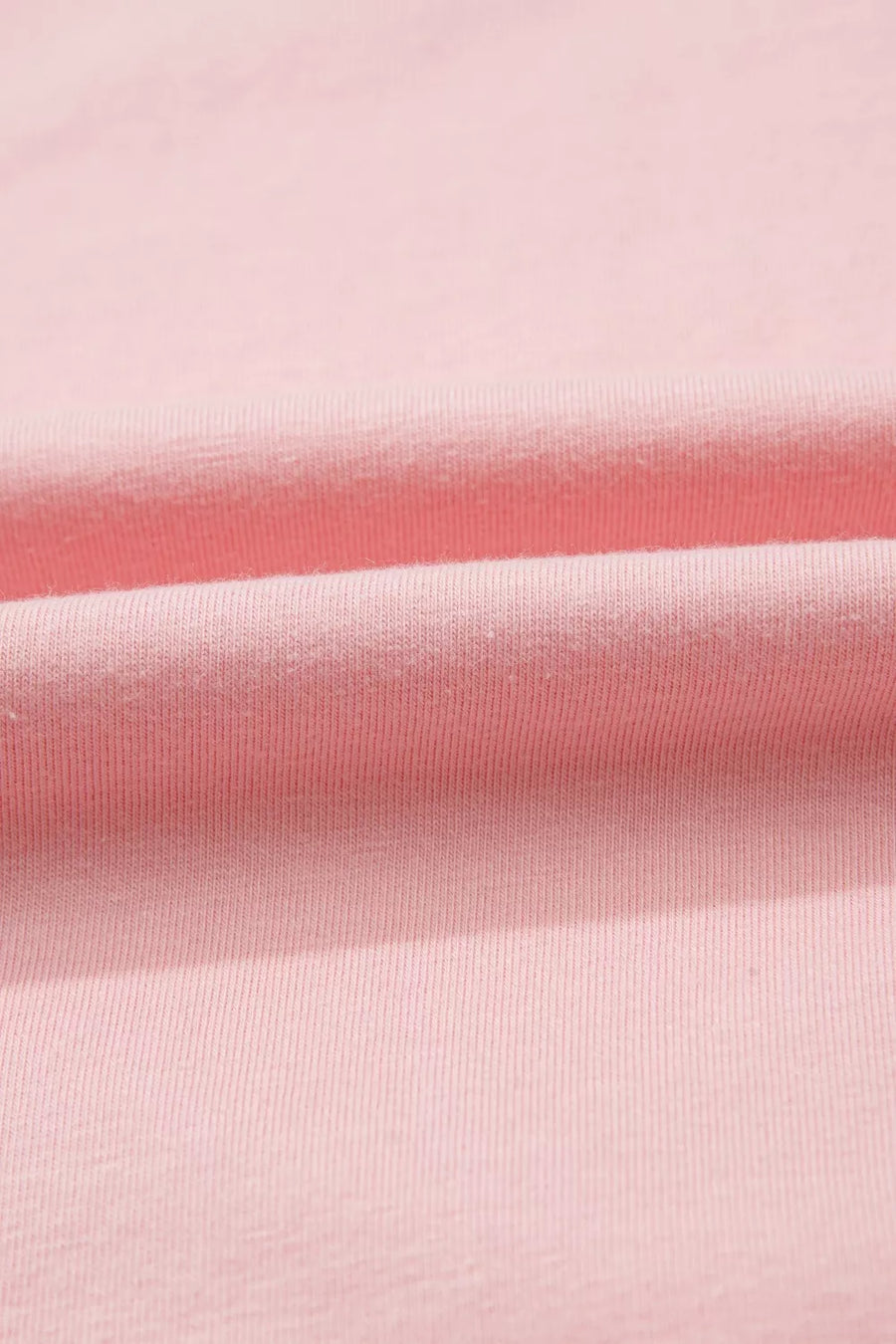 Pink cotton maternity t-shirt with subtle ribbing and soft folds.