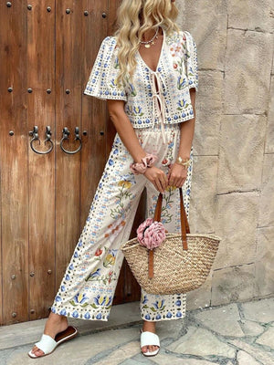 Floral tie-front cropped top and wide-leg pants set with blue and yellow botanical print.