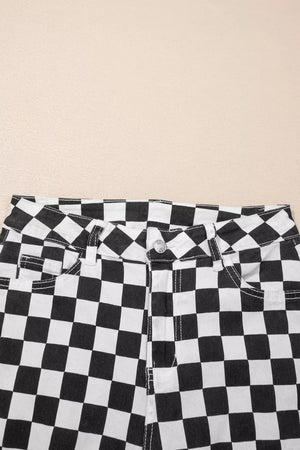 Checkerboard distressed cropped jeans in black and white denim with a button fly.
