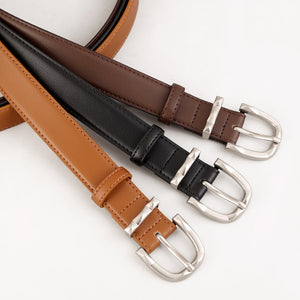 Timeless cowhide leather skinny belts in brown, coffee brown, and black with brushed silver buckles.