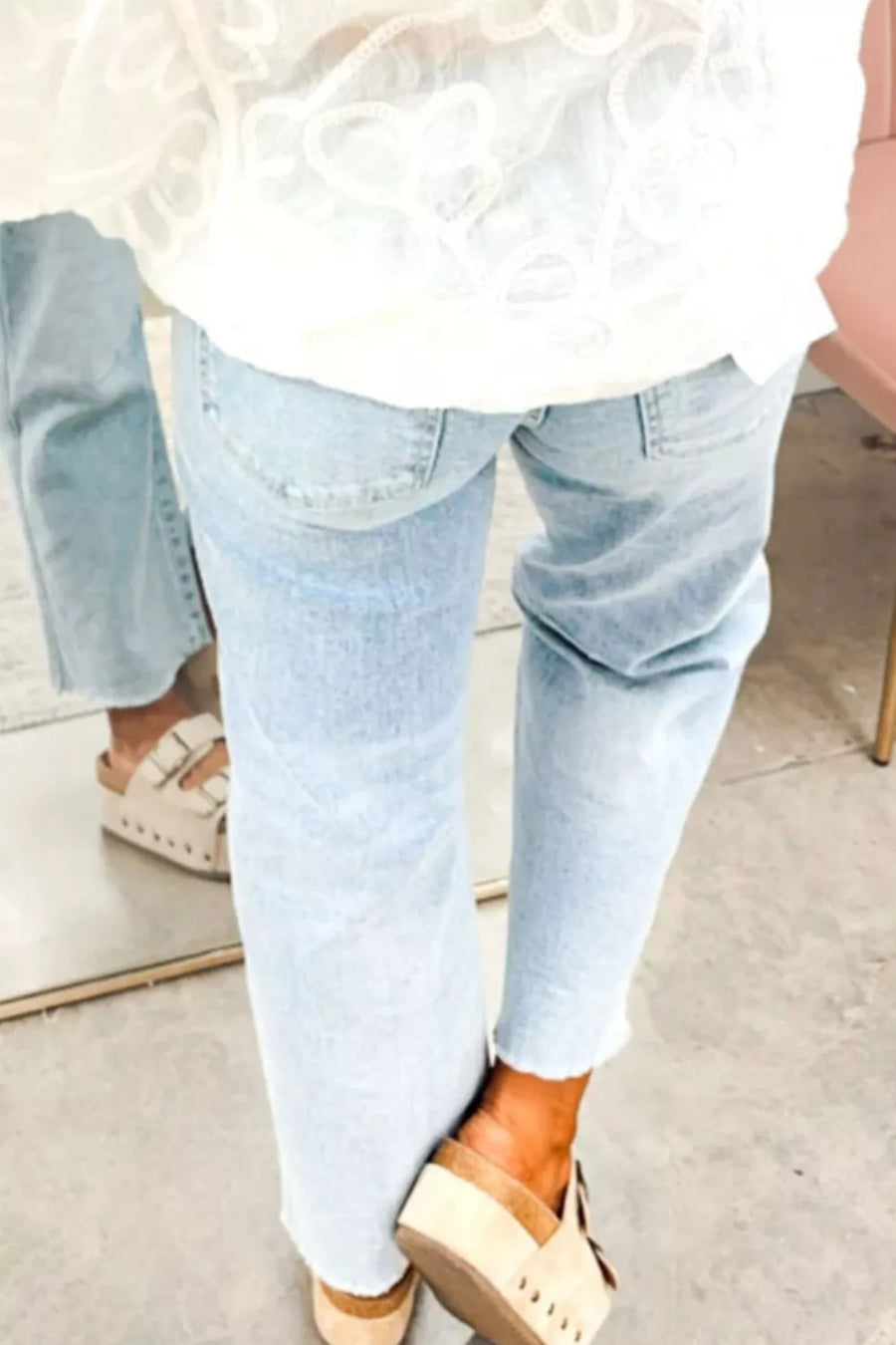 Light wash denim cropped utility jeans with frayed hem and subtle starry sequin detail.