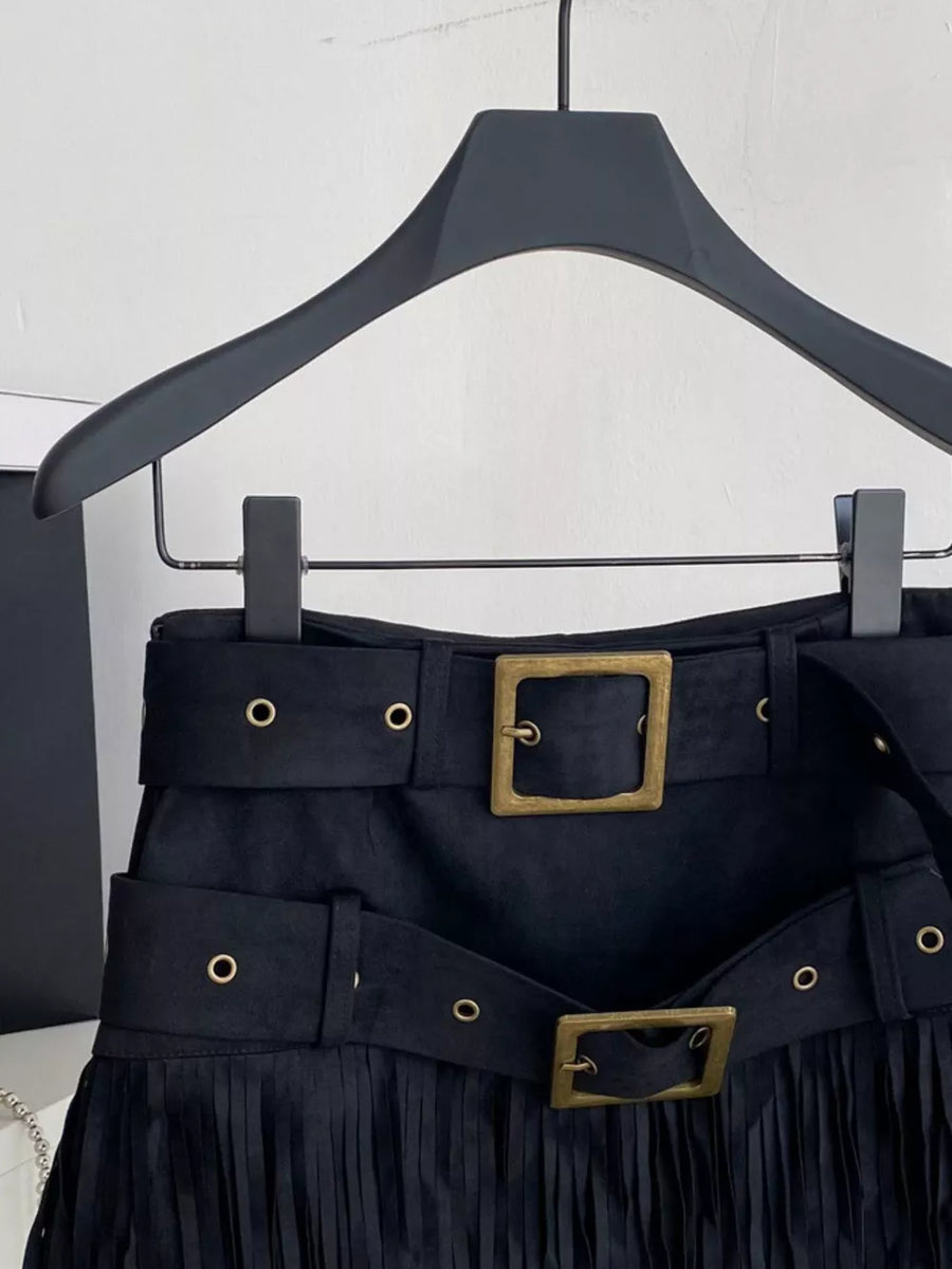 Black belted mini skirt with fringe hem and antique brass buckle detail.