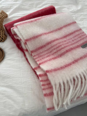 Pink and white striped scarf with fringe hem and a solid red scarf.
