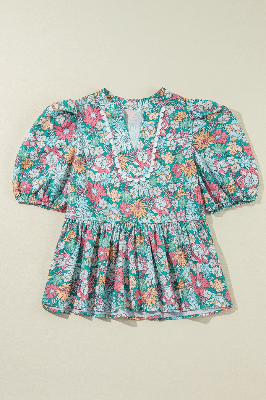 Floral peplum blouse with scallop trim and puff sleeves