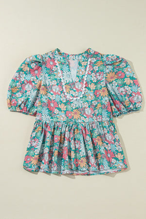 Floral peplum blouse with scallop trim and puff sleeves