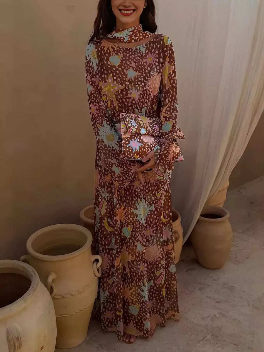 Maxi dress with celestial print, long sleeves, and mock neck, paired with a matching clutch.