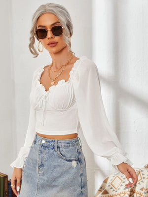 White bustier sleeve blouse with ruffled neckline and tie detail