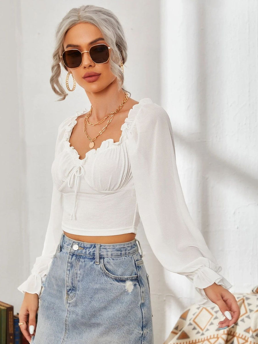 White bustier sleeve blouse with ruffled neckline and tie detail