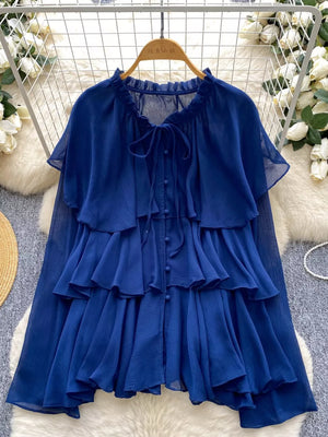 Blue chiffon tiered shirt with ruffled details and bow tie neckline.