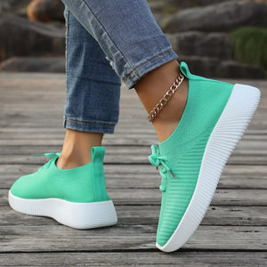 Light green breathable lace-up sneakers with white mid sole and ribbed texture.