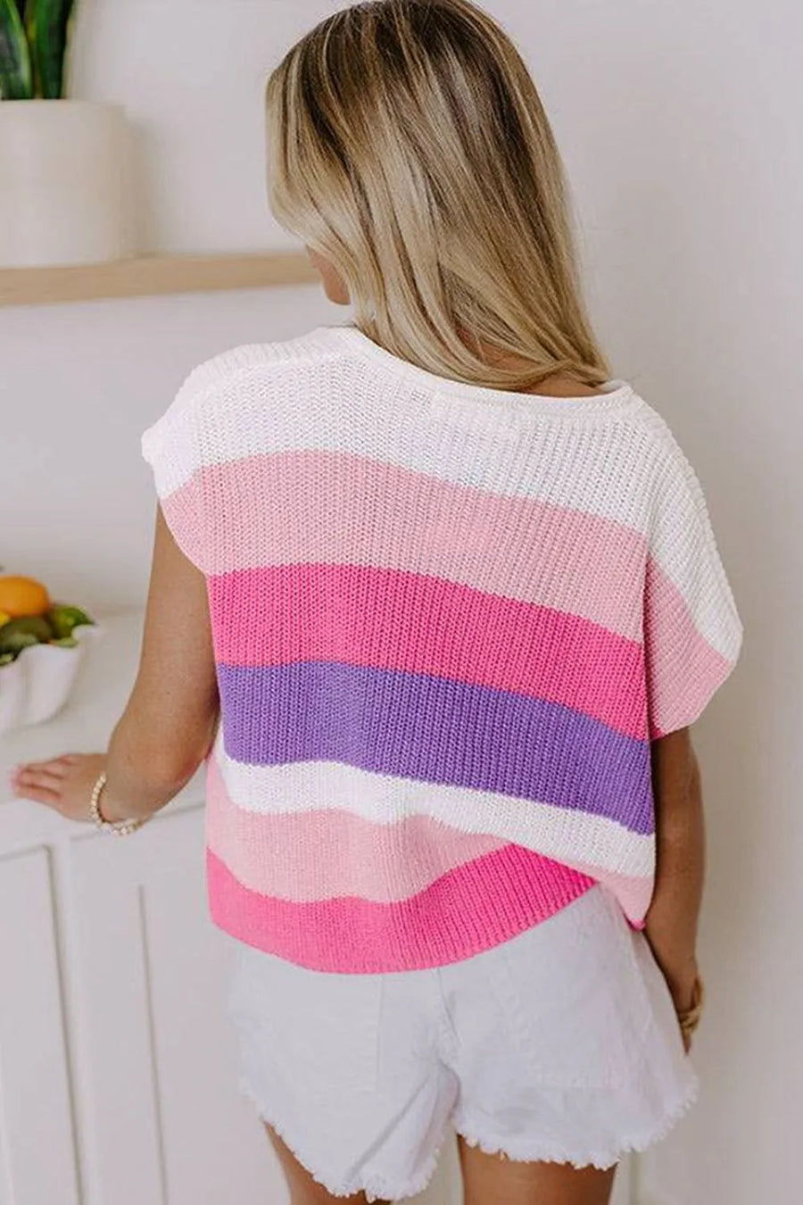 Colorblock knit polo top with short sleeves in pink, purple, and white stripes.