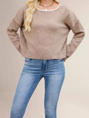 Black pullover sweater with exposed seam and long sleeve