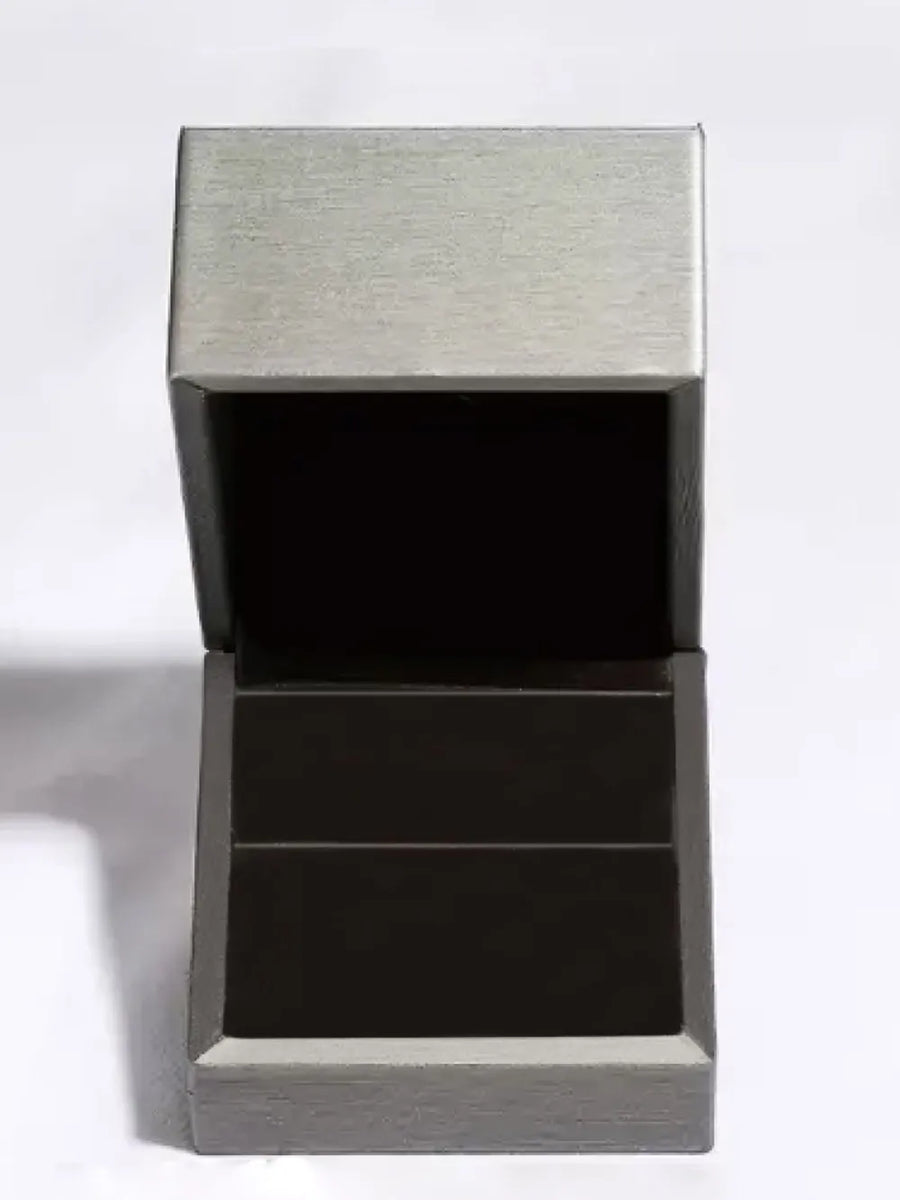 Open jewelry box with brushed silver lid and dark interior