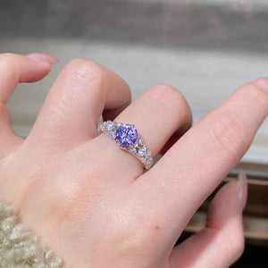 silver ring featuring faceted stones and ornate