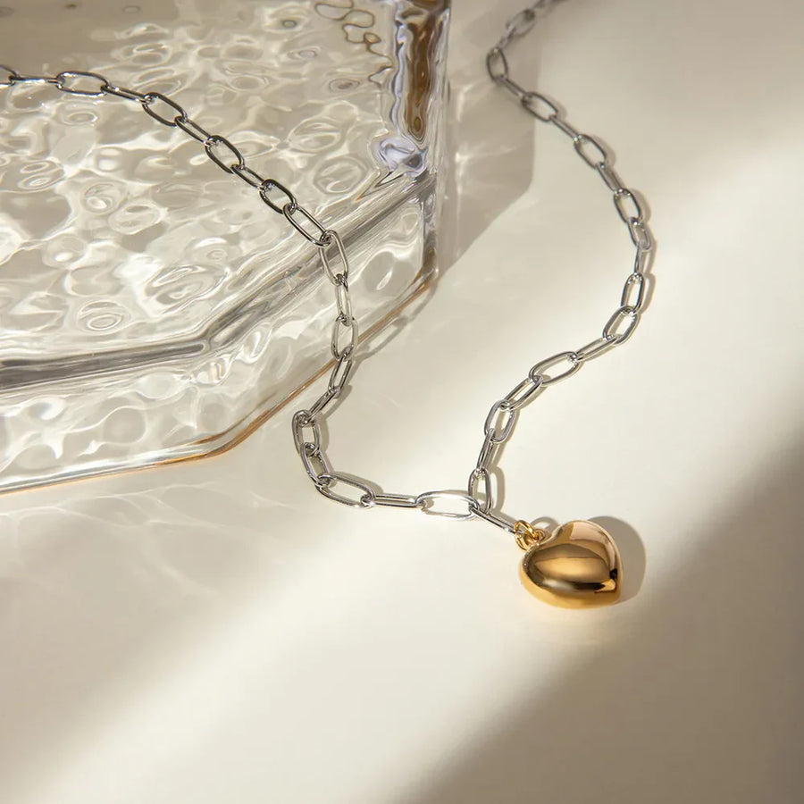 Two-tone heart chain necklace with a gold heart charm and silver chain.