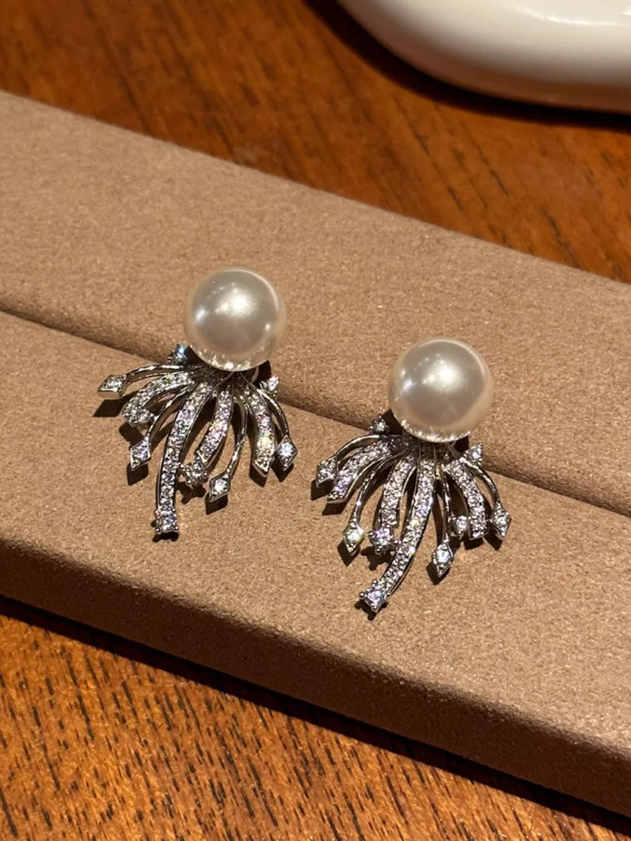 Luminous pearl and zircon silver earrings with delicate cascading design.