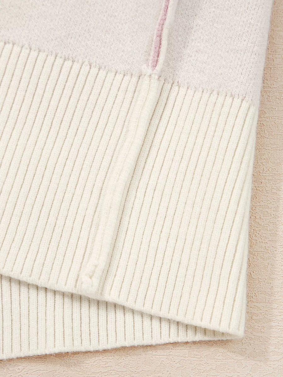 Beige acrylic blend sweater with ribbed hem and a subtle pink detail.