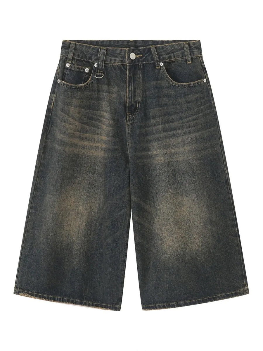 Wide-leg denim culottes in a dark, distressed wash with a raw hem.