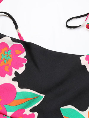 Black midi dress with vibrant floral print and spaghetti straps.