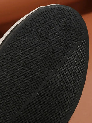 Embellished suede ballet flats with a textured black sole.