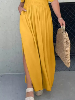 Yellow V-neck maxi dress with smocked waist, dolman sleeves, pockets, and high slits.