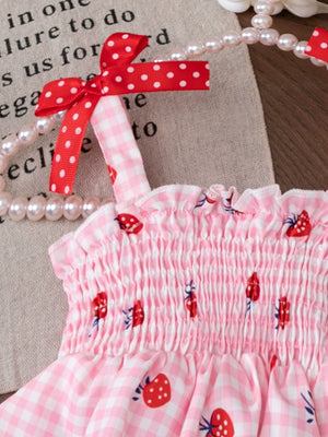 Pink smocked strawberry top with white gingham and red polka dot bows.