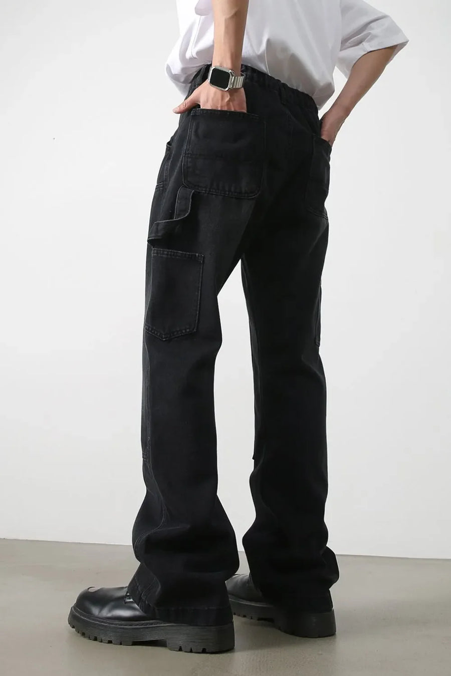 Dark wash denim wide leg carpenter jeans with utility pockets.