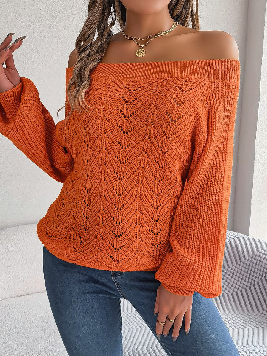 Pumpkin open-knit off-shoulder sweater with voluminous sleeves and intricate leaf pattern.