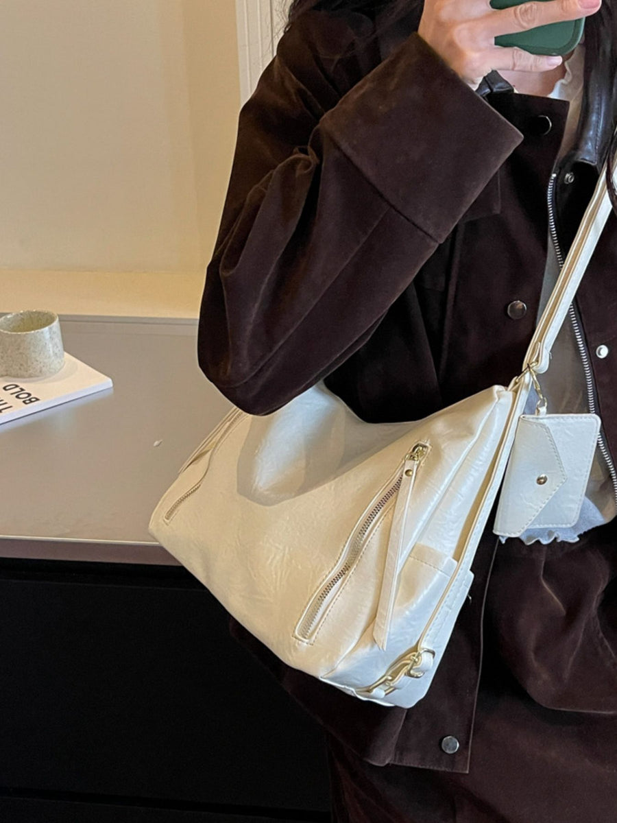 shoulder bag in cream with zipper pockets and medium