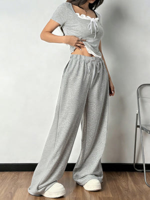 Grey tie front cropped top with white trim and drawstring wide-leg pants set.