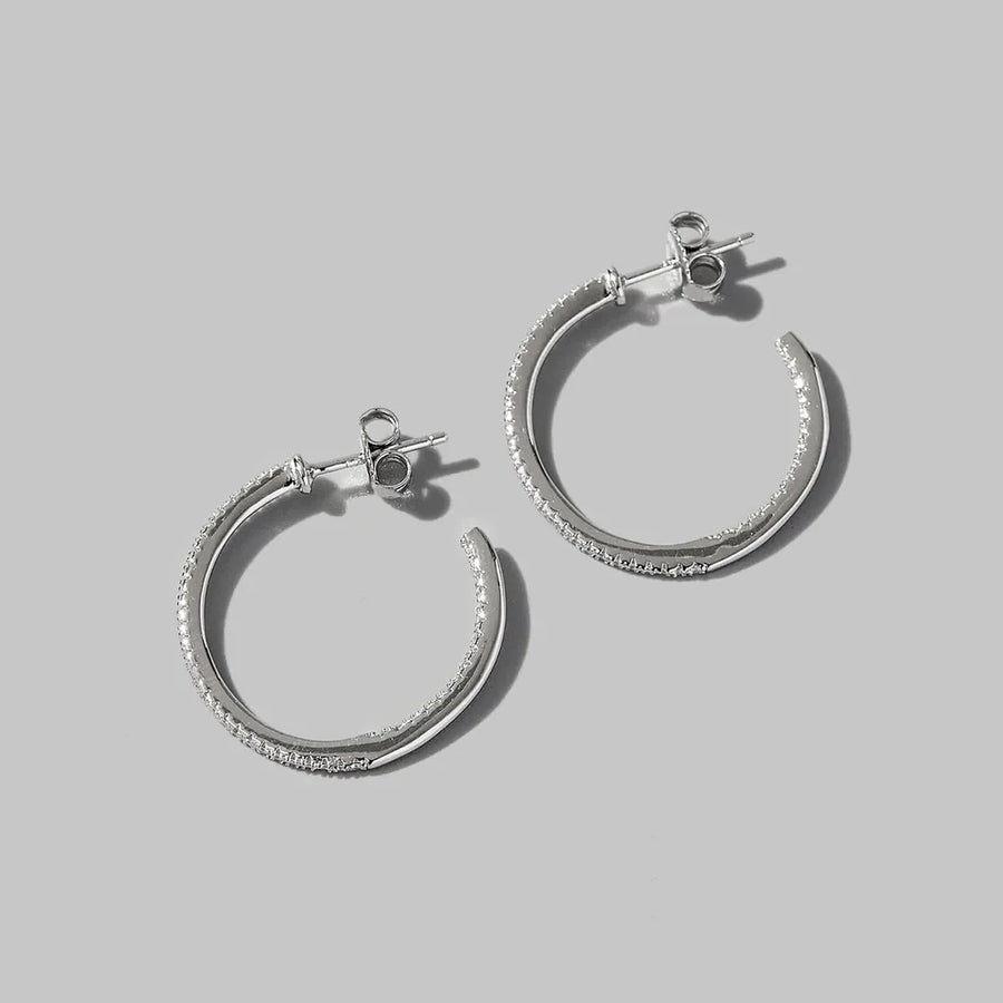 Silver pavé zirconia half-hoop earrings in 925 sterling silver.
