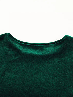 Dark green velvet mini dress with puff sleeves and tiered skirt detail.