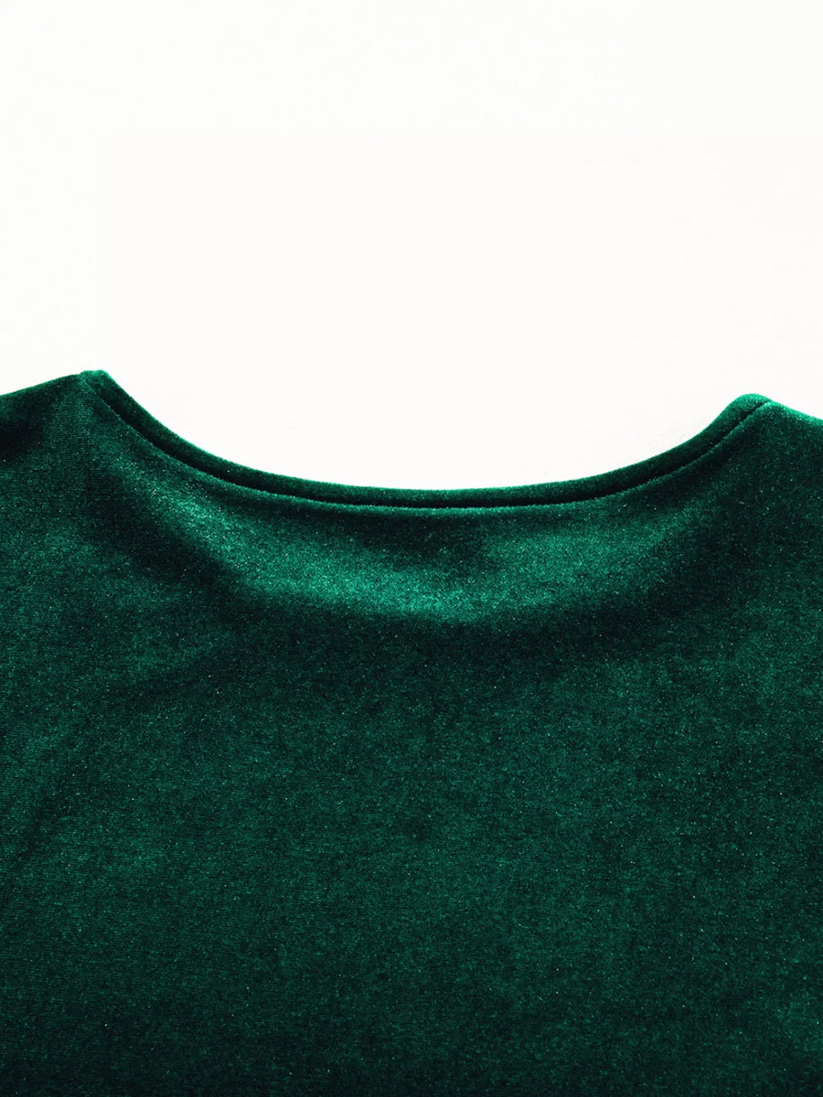 Dark green velvet mini dress with puff sleeves and tiered skirt detail.