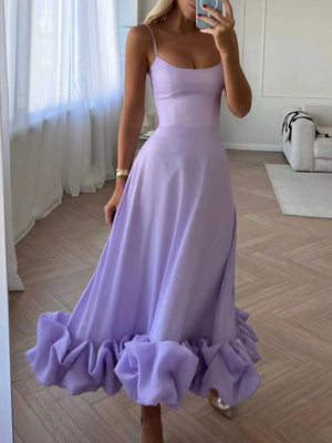 Lavender midi dress with spaghetti straps and a ruffled hem.